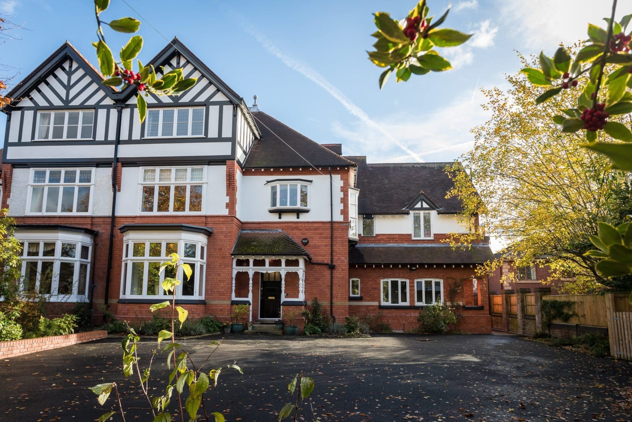 a large red brick house with white windows.