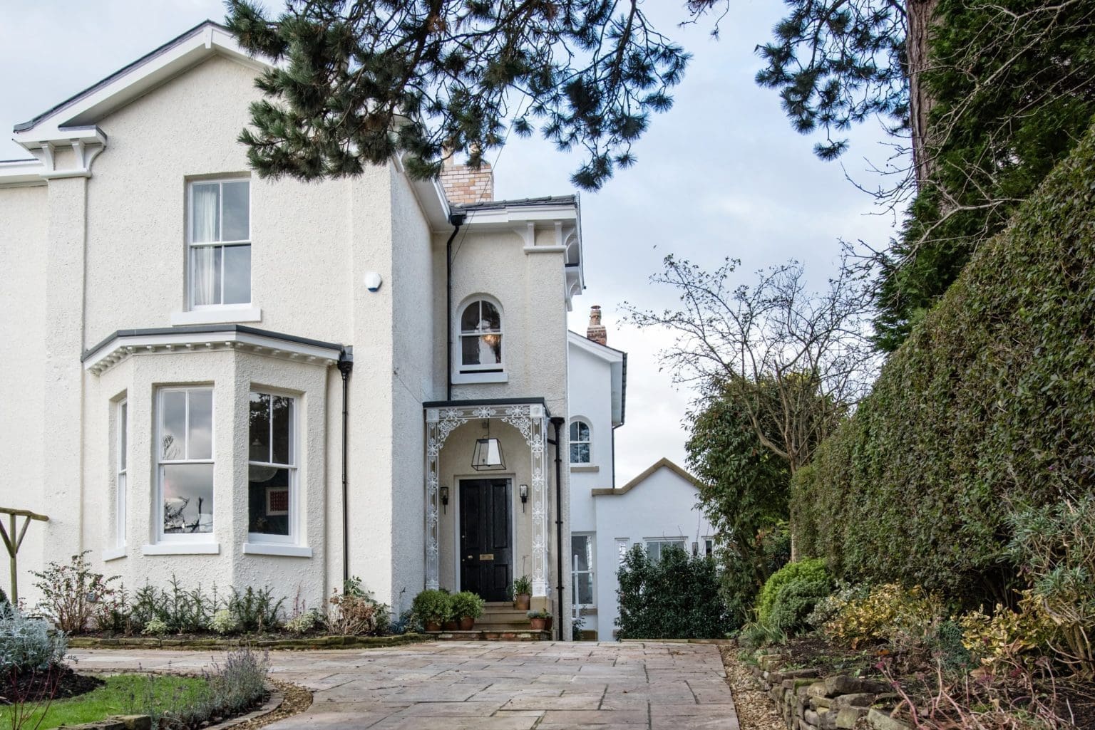 a large white house with a large driveway.