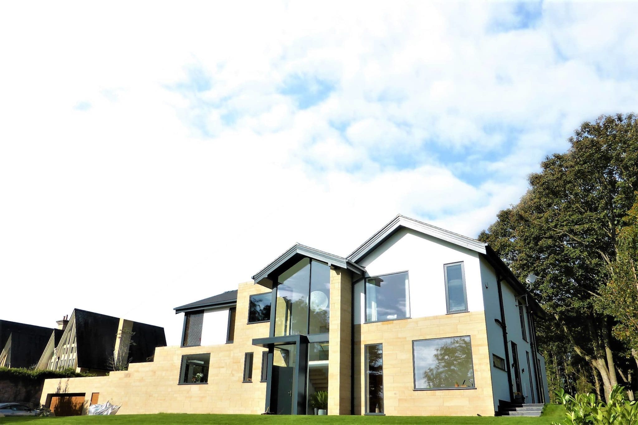 a house with a large lawn in front of it.