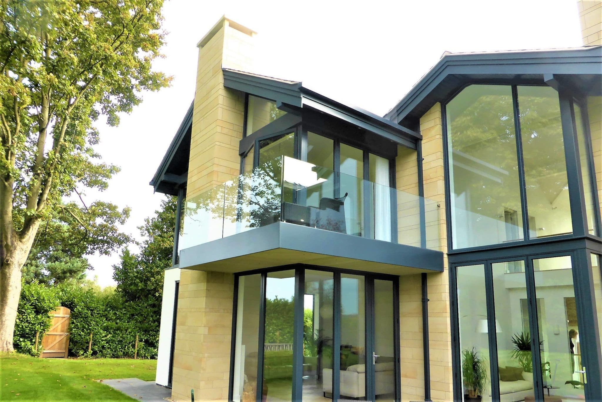 a large house with a lot of windows and a balcony.