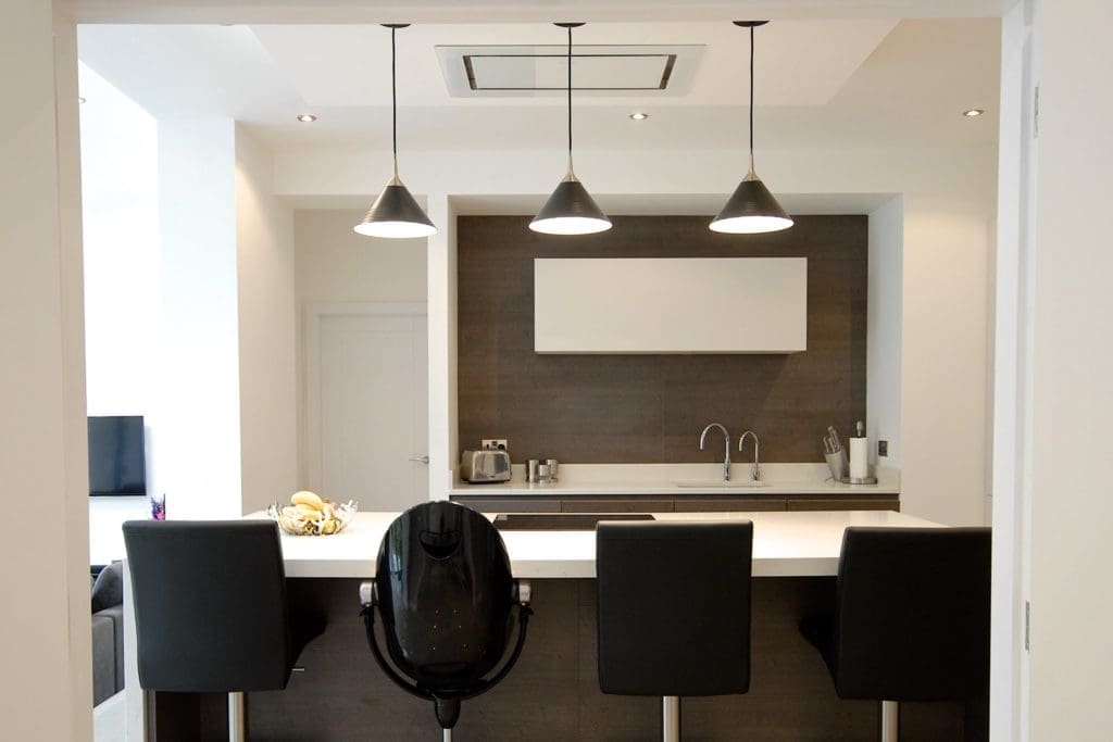 a kitchen with a lot of counter space and chairs.