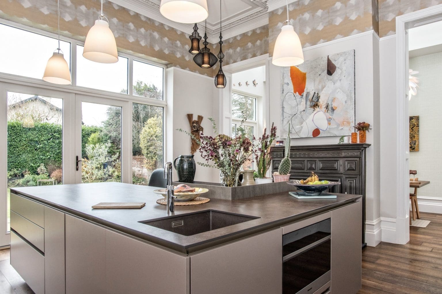 a kitchen with a sink and a stove top oven.