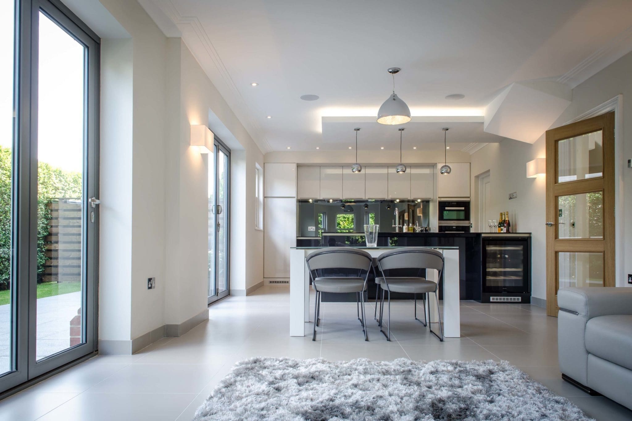 a living room filled with furniture and a kitchen.