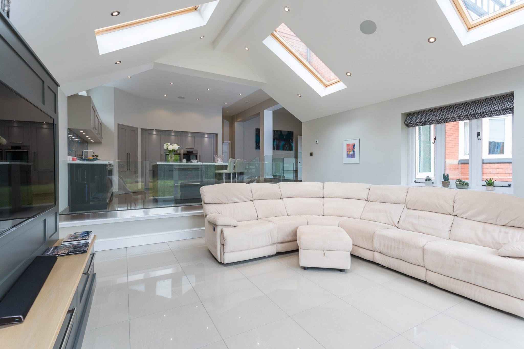 a living room with a white couch and a flat screen tv.