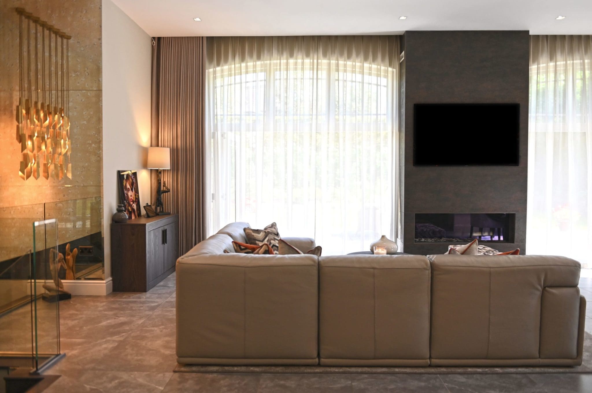 a living room with a large couch and a flat screen tv.