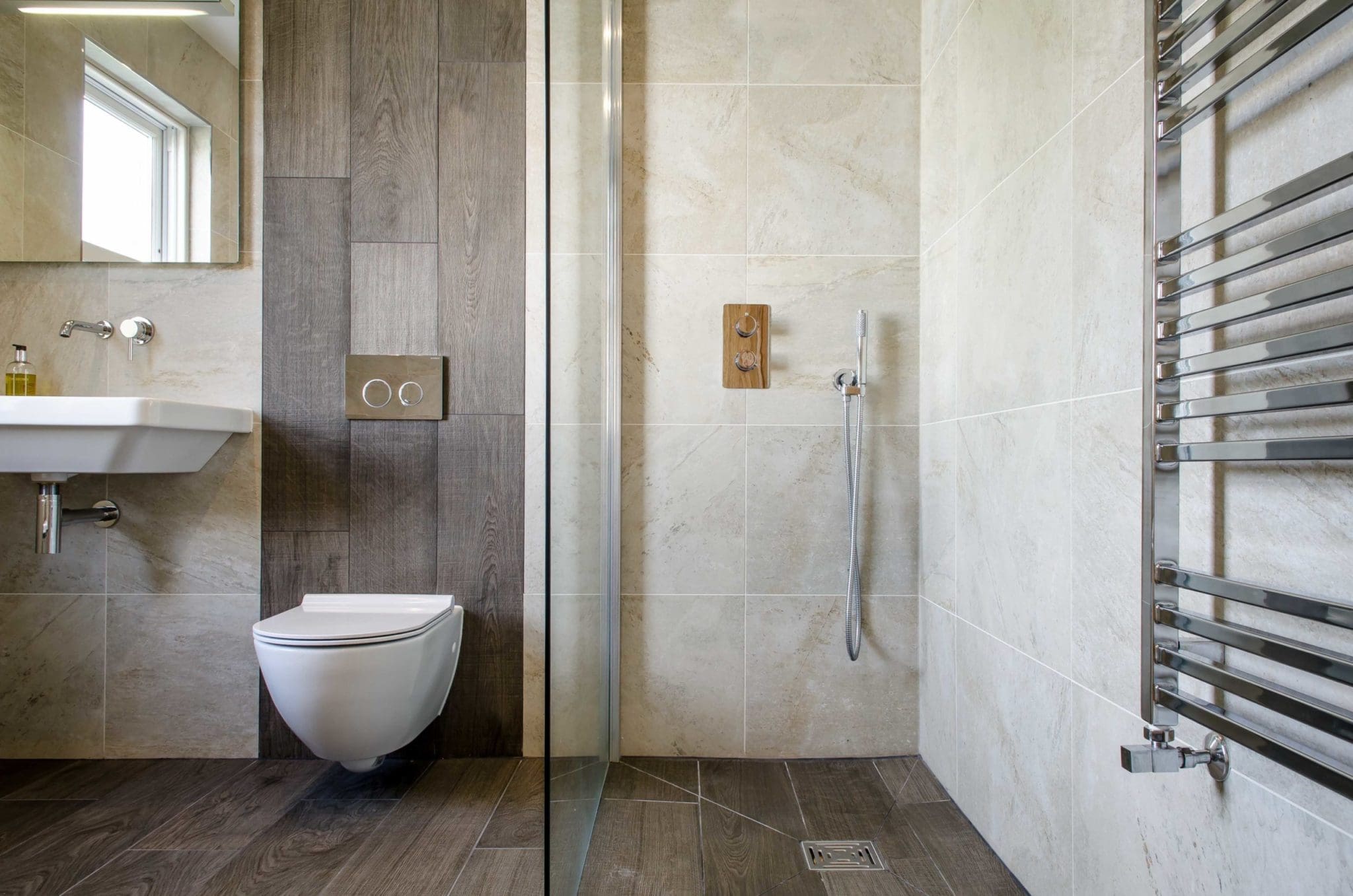 a white toilet sitting next to a walk in shower.