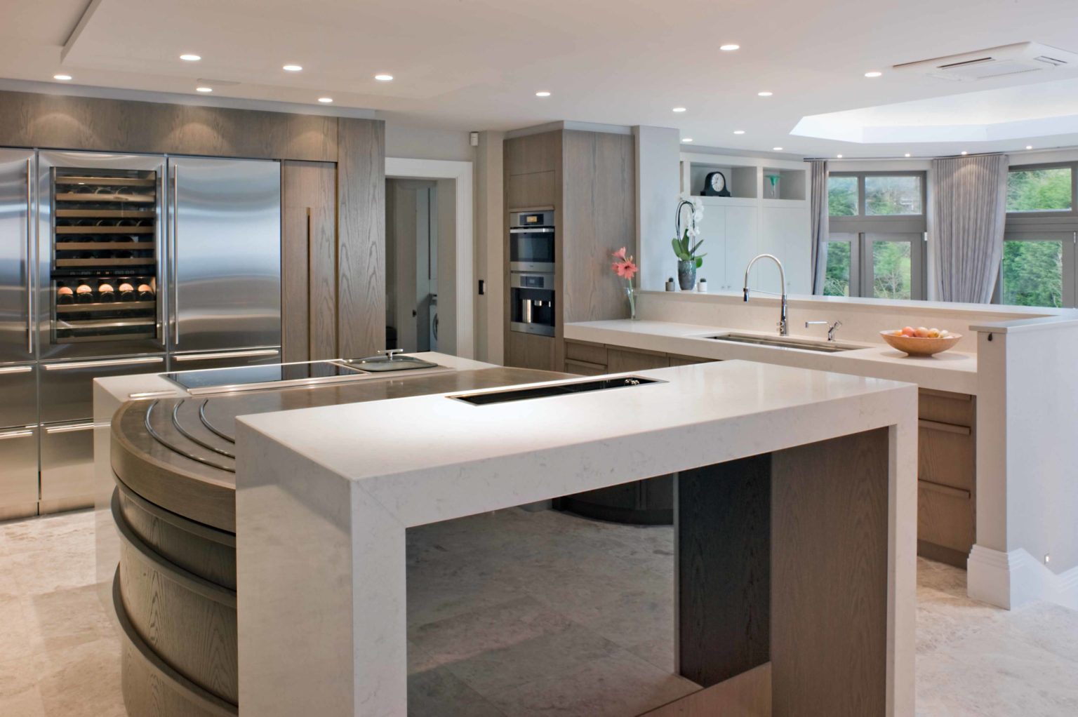 a modern kitchen with a large island in the middle of the room.