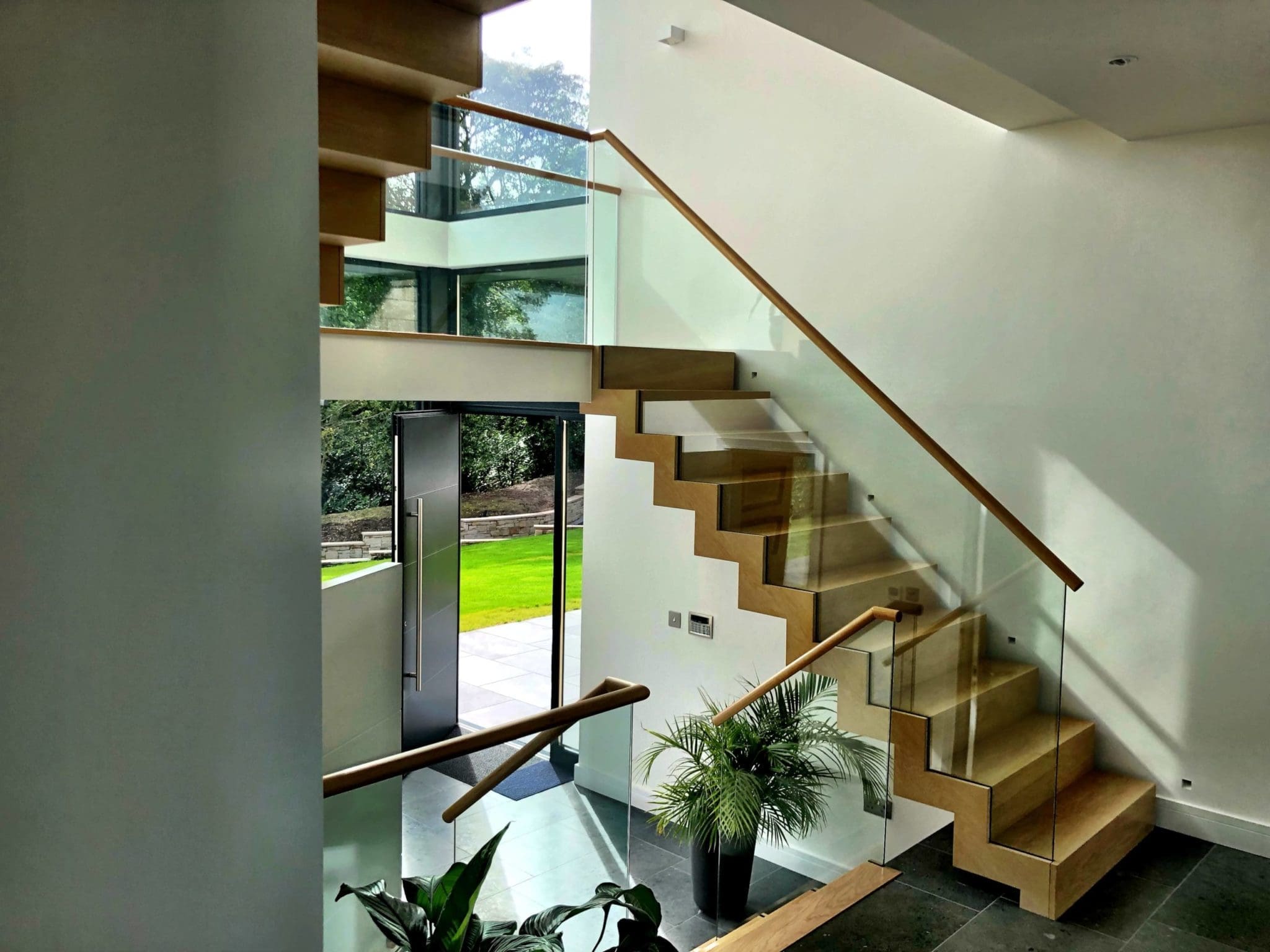 a stair case in a house with a potted plant.