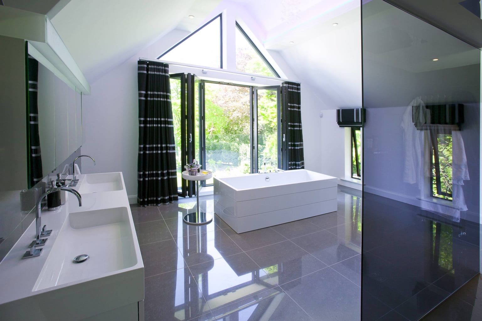 a bathroom with a large tub and a sink.