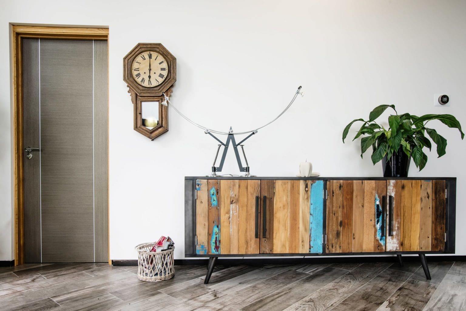 an indoor wooden cabinet with a clock on the wall.