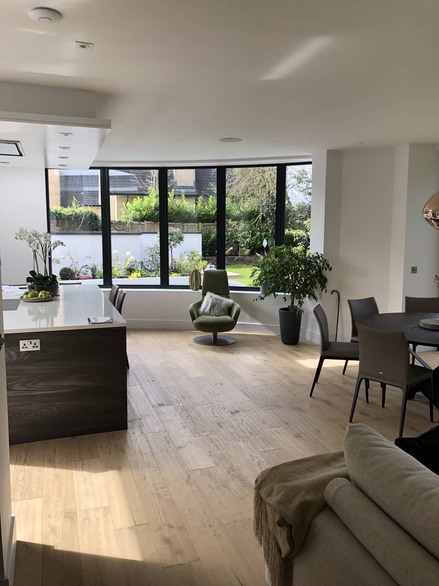 a living room filled with furniture and a large window.