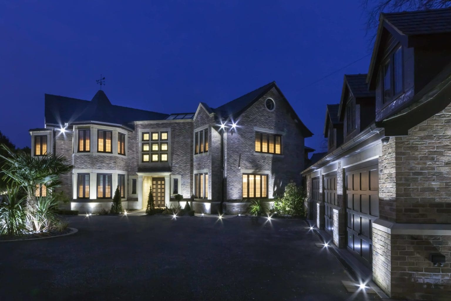 a large house with a lot of lights on it.