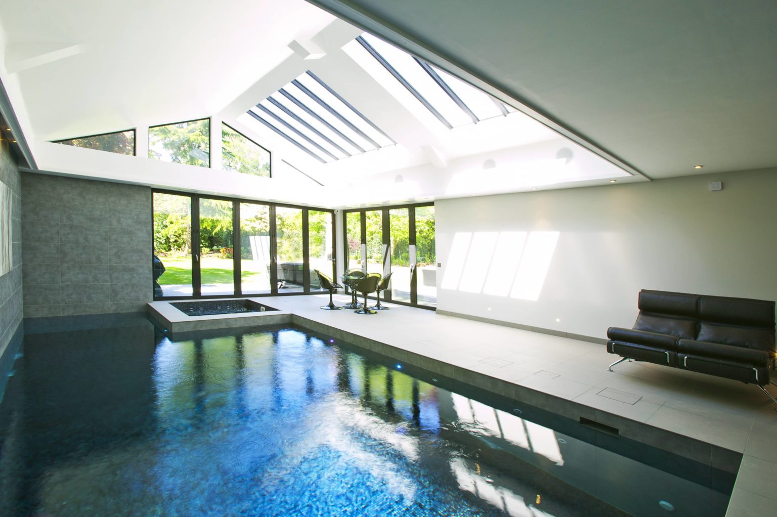 a large indoor swimming pool in a house.