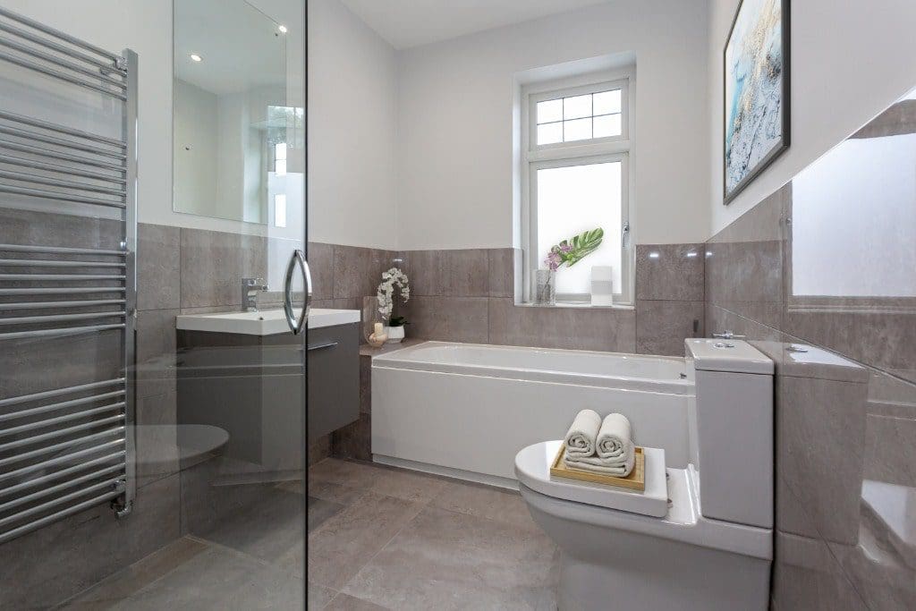 a bathroom with a toilet, sink, and bathtub.
