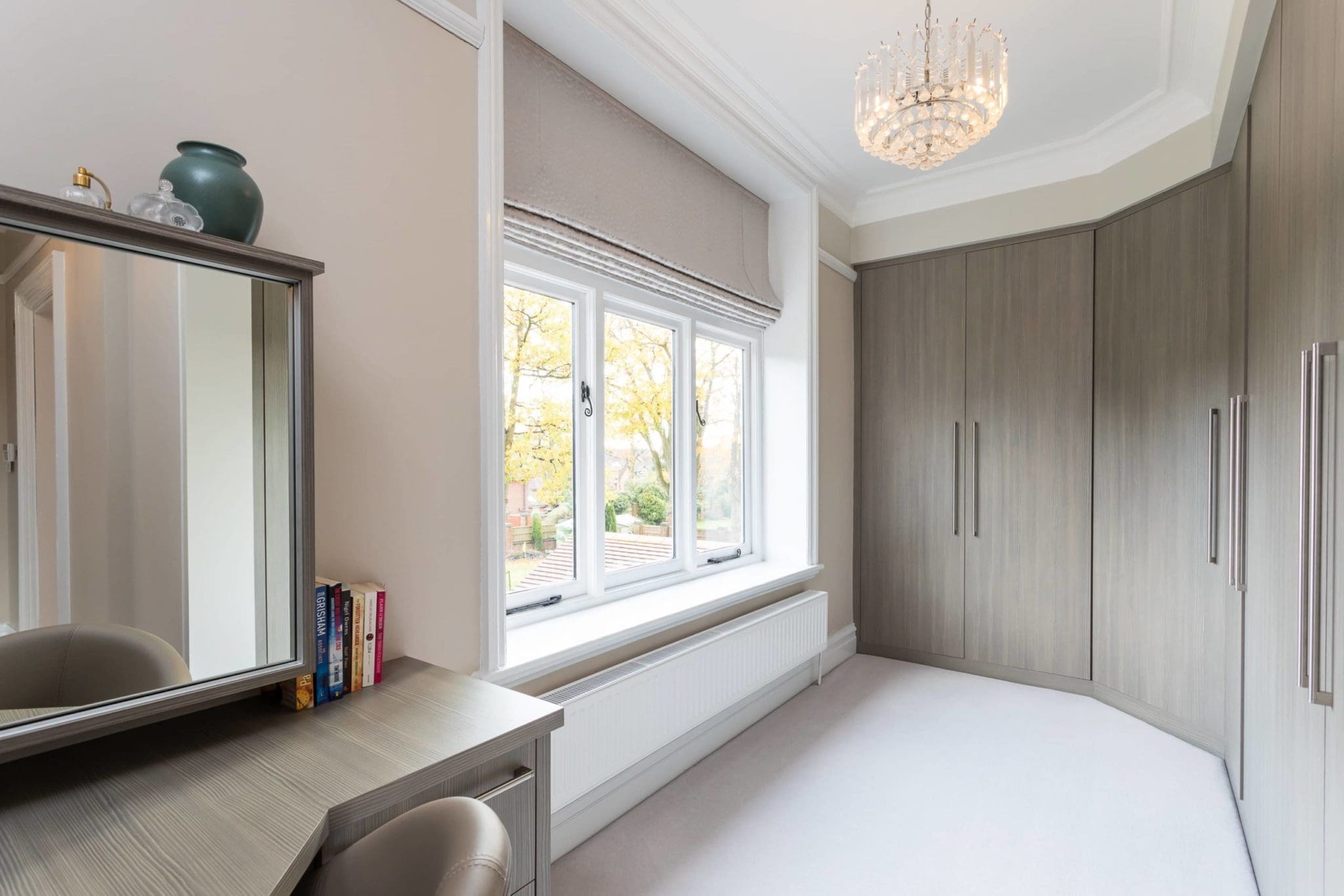 a room with a large mirror and a desk.