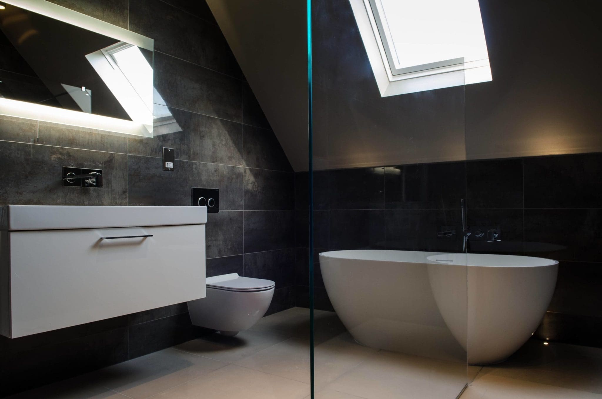 a white toilet sitting next to a white sink in a bathroom.