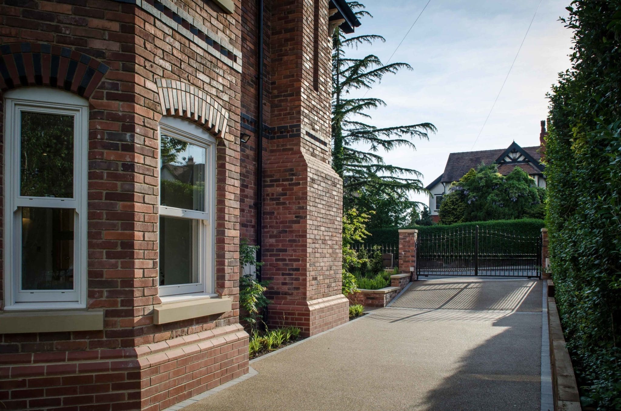 a brick building with a gate and windows.
