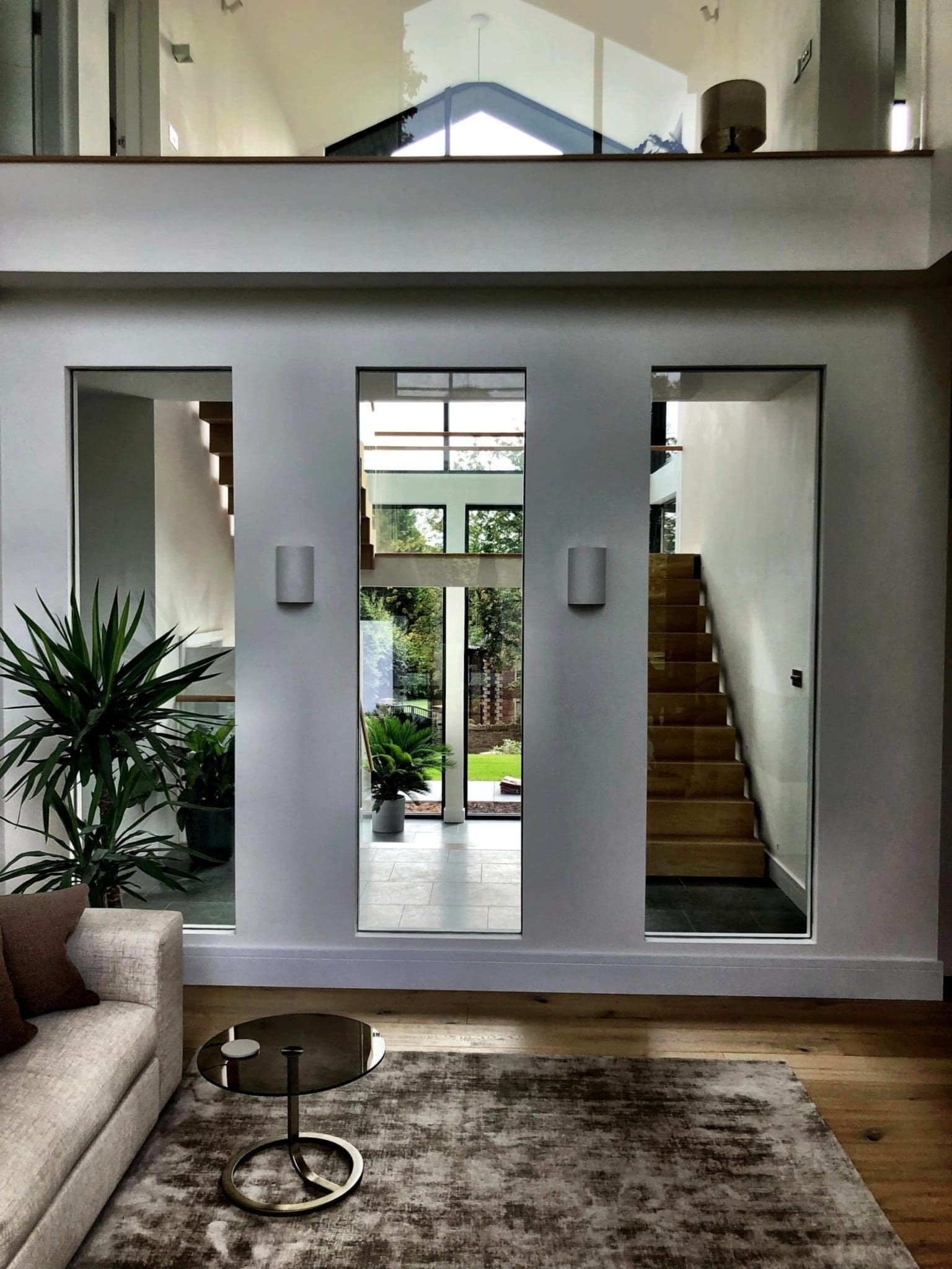 a living room with a couch a table and a stair case.
