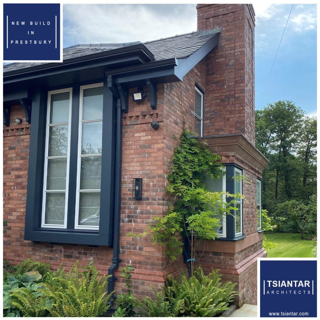 A Cloverdale brick house with a blue window and black shutters.