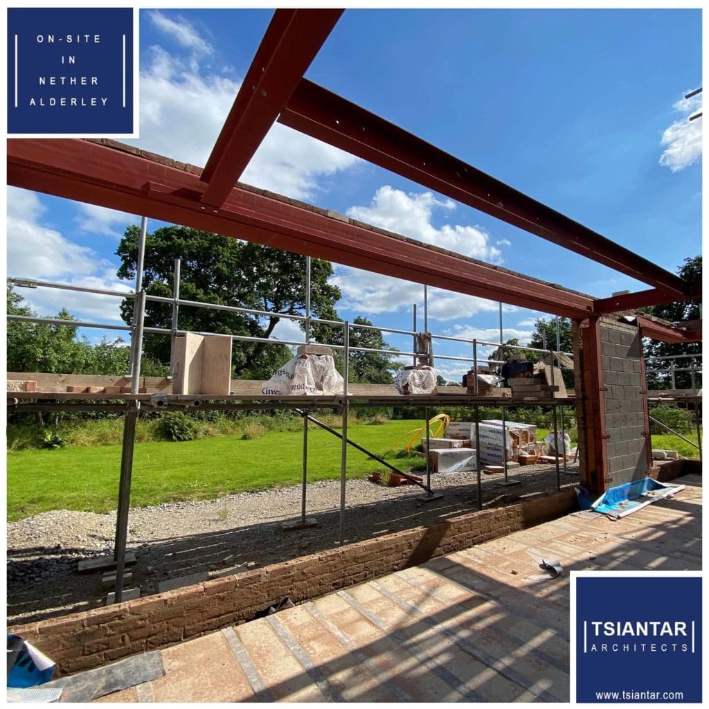 A metal-framed house under construction on-site in Nether Alderley.