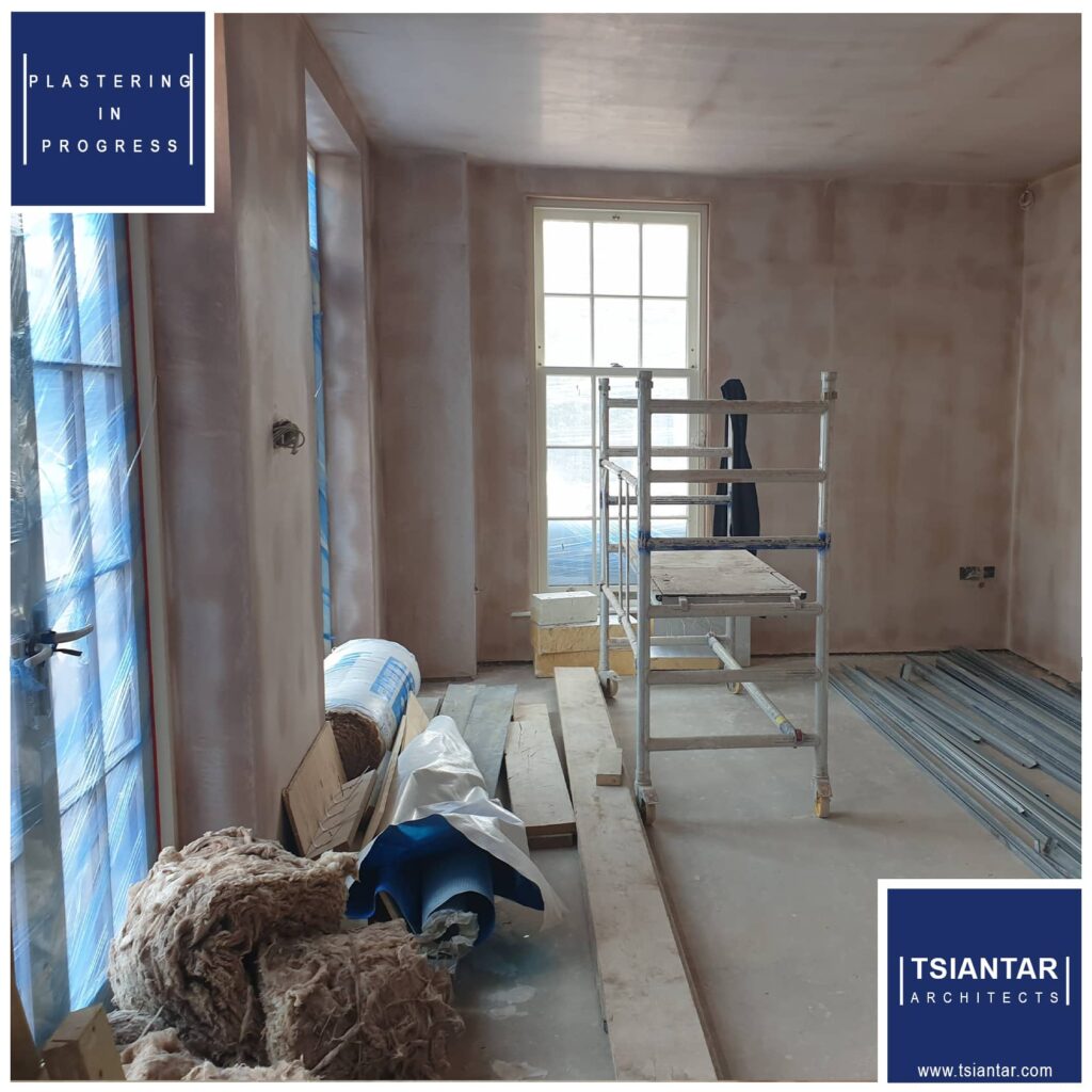 A room in Cheshire East is undergoing renovation with blue walls and a ladder, showcasing progress.