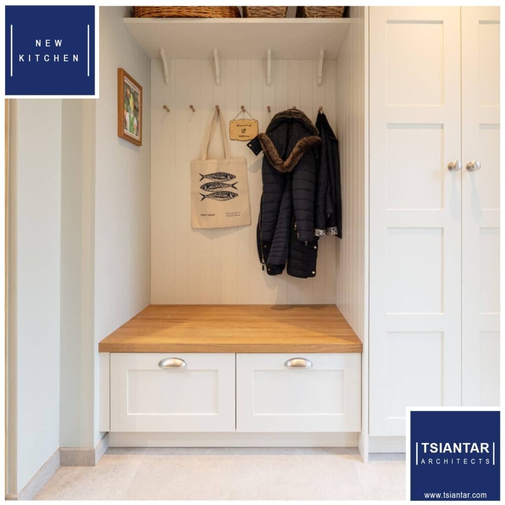 A farmhouse mudroom with coat racks and a wooden bench.