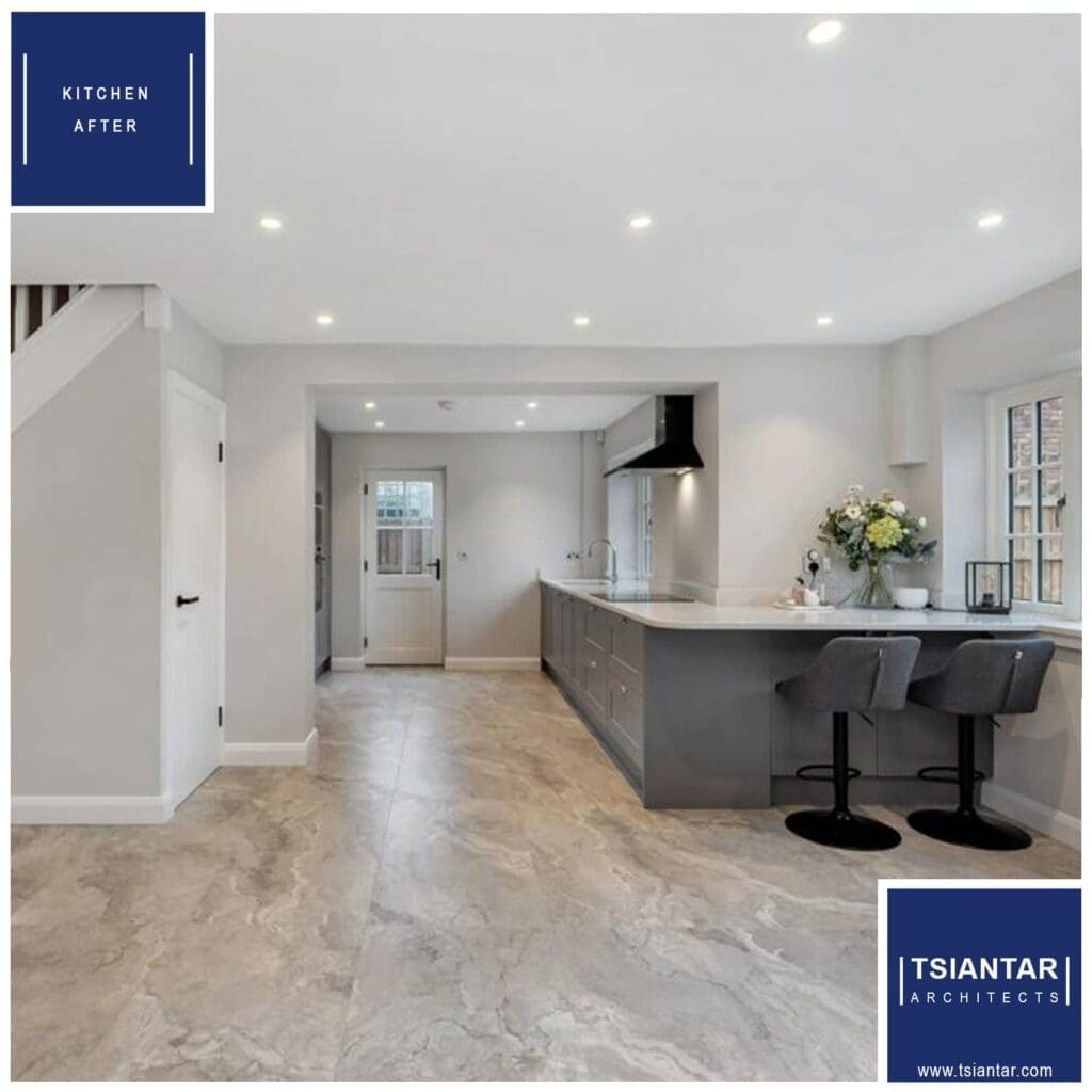 Modern house transformation with a sleek gray island, bar stools, and stone flooring.