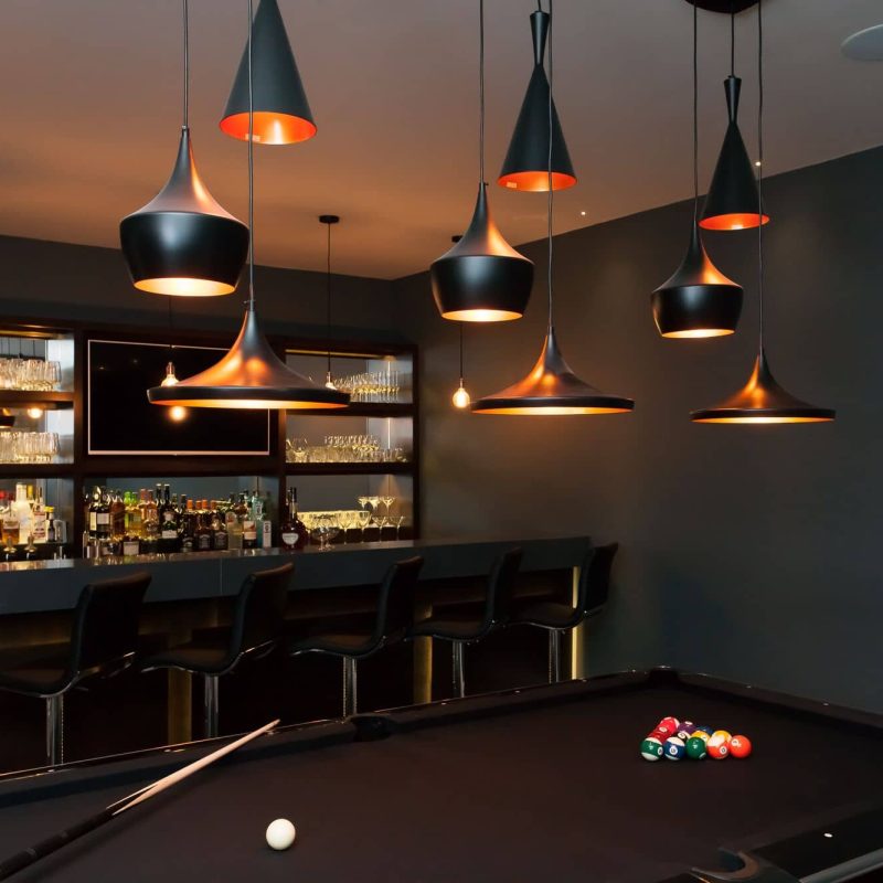 A billiard room with a pool table and a bar.