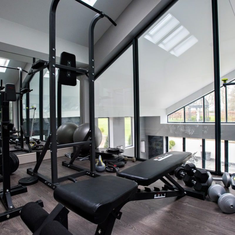 A gym room with a lot of equipment.